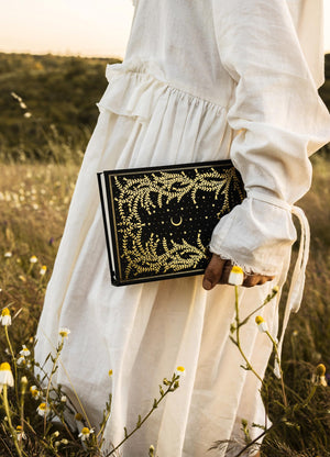 The Herbology Journal in black and gold foil. A Botanical grimoire for witches by Cocorrina & Co Shop captured by Julia Brenner