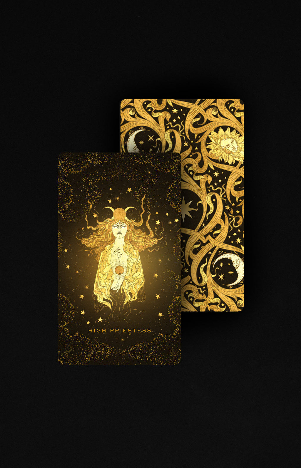 Two tarot cards, one featuring a woman and the other with intricate gold designs on a black background.