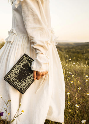 The Herbology Journal in black and gold foil. A Botanical grimoire for witches by Cocorrina & Co Shop captured by Julia Brenner