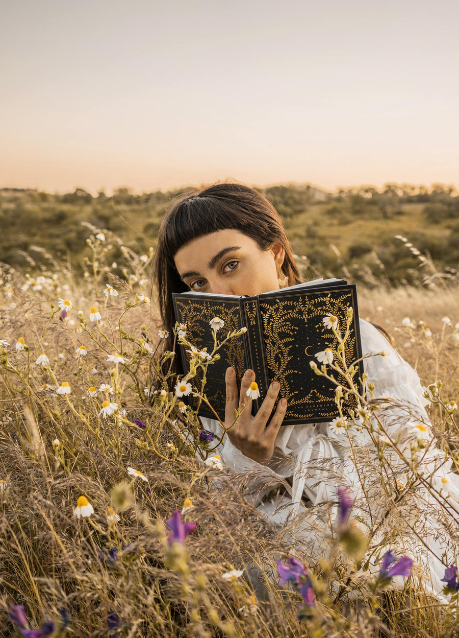 The Herbology Journal in black and gold foil. A Botanical grimoire for witches by Cocorrina & Co Shop captured by Julia Brenner