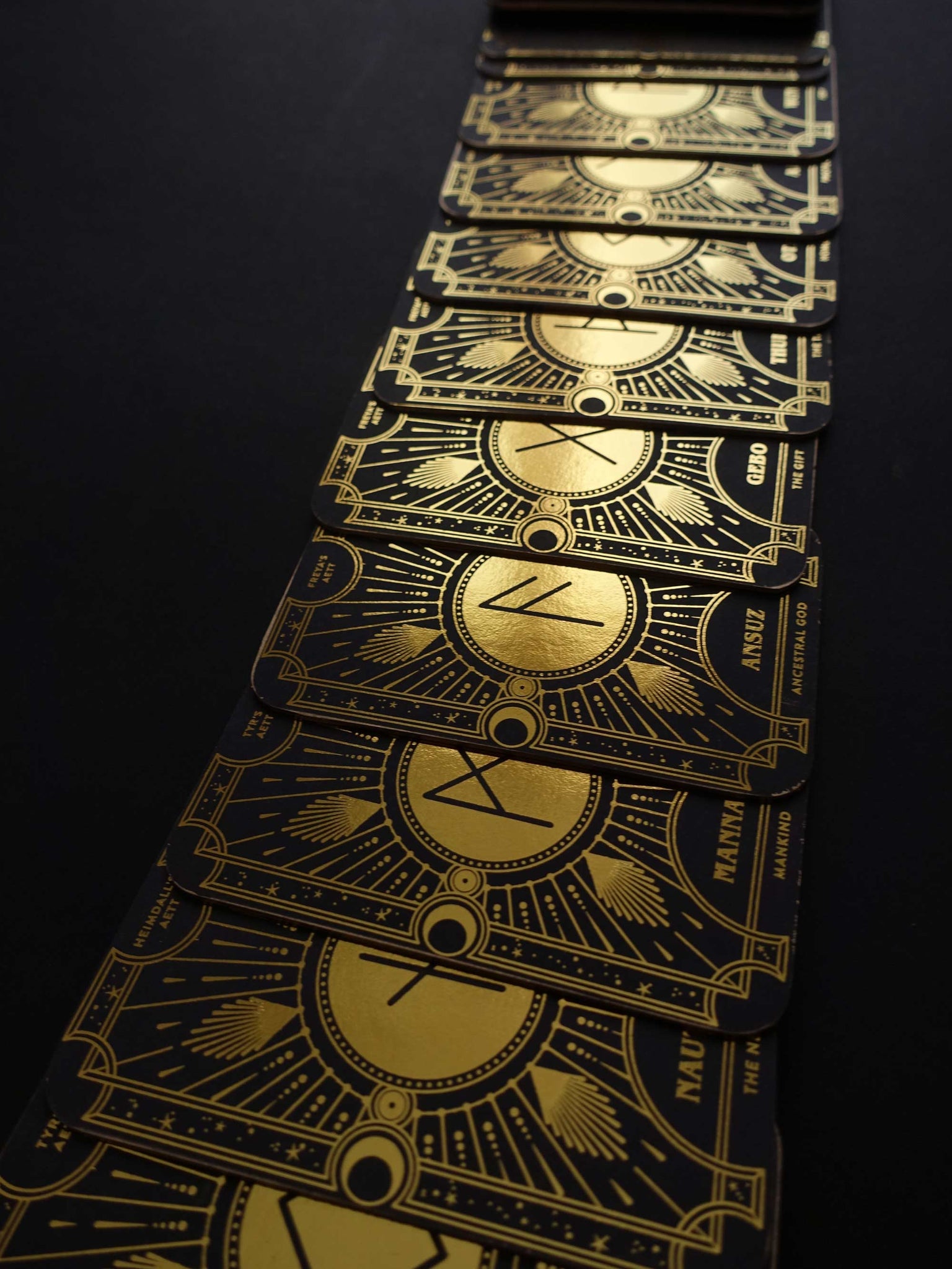 Cosmic Whisper rune deck by Cocorrina & Co in black and gold foil